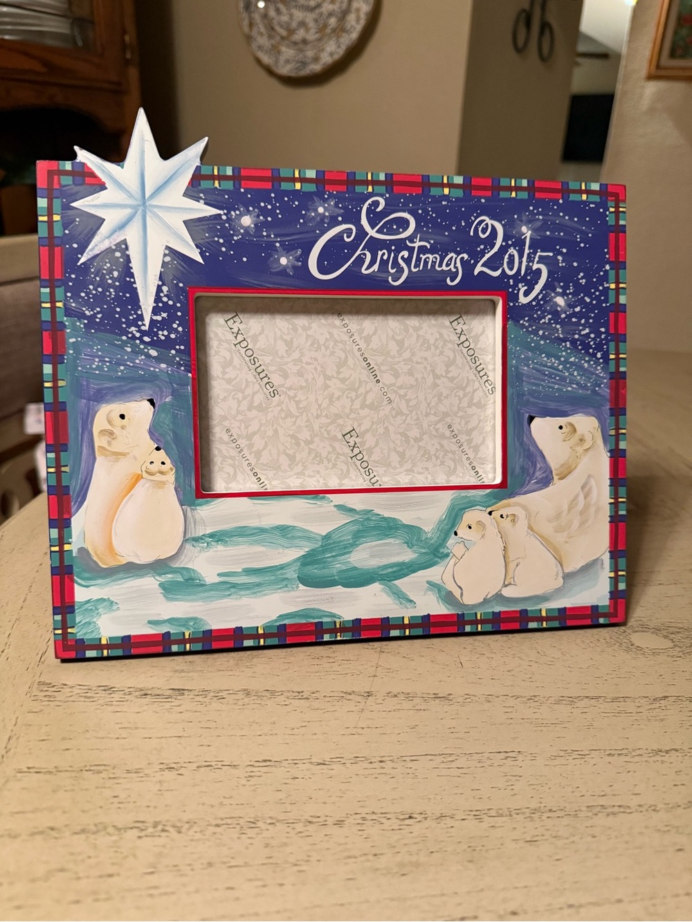 Exposures Christmas photo frame featuring a watercolor-style winter